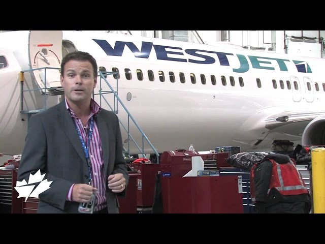Richard Bartrem in front of WestJet plane