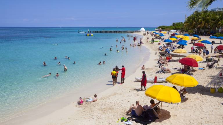 Travellers relaxing on the beach in Montego Bay