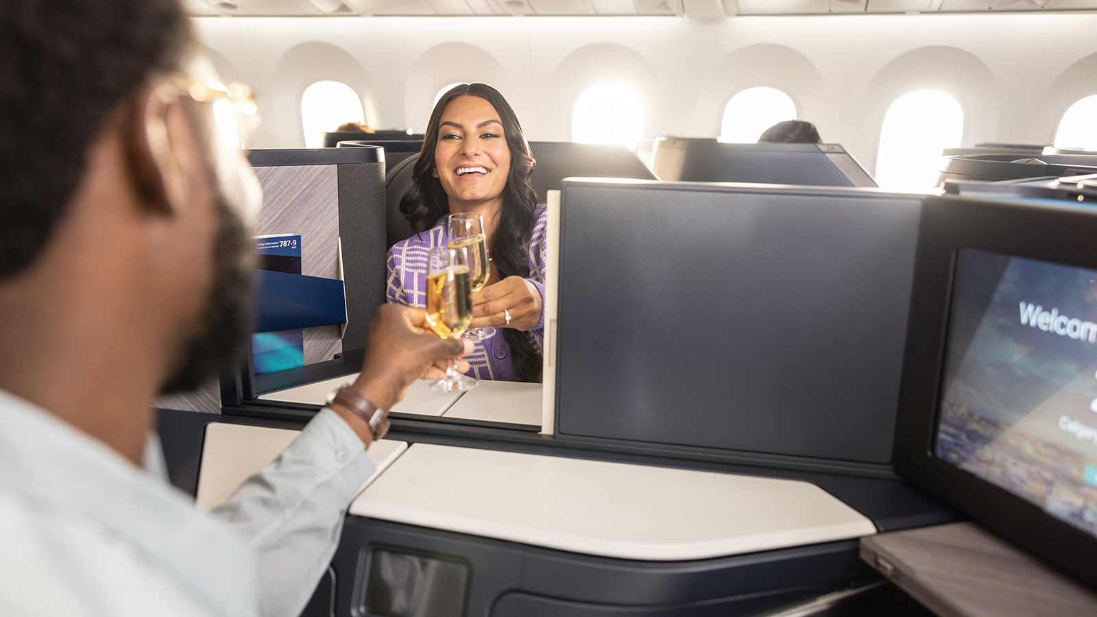 Couple enjoying drinks in WestJet business class