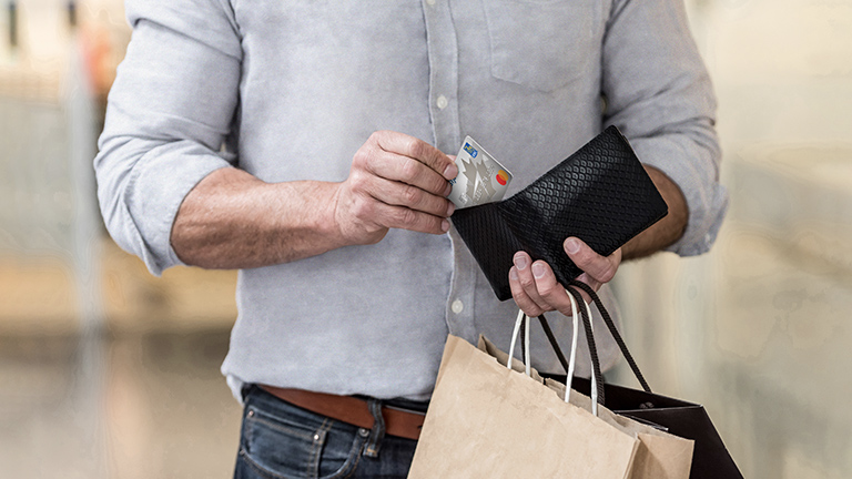 Guest holding a WestJet RBC® Mastercard‡ 