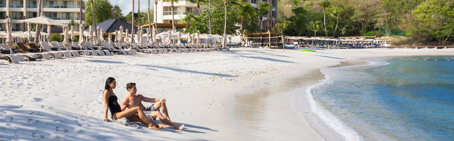 Couple relaxing on beach at Hideaway at Royalton St. Lucia